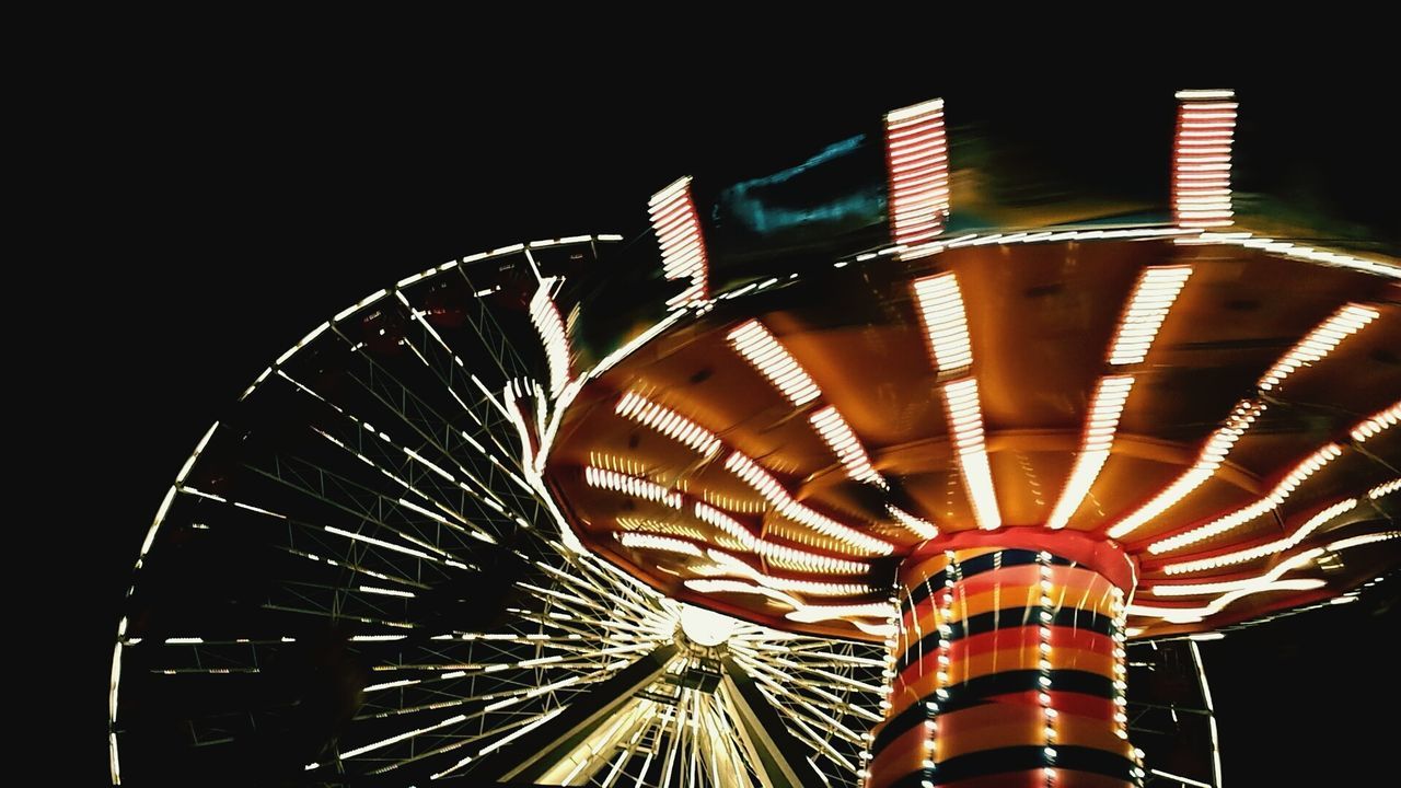 ferris wheel, amusement park ride, amusement park, arts culture and entertainment, built structure, low angle view, architecture, night, illuminated, travel destinations, clear sky, famous place, building exterior, city, tourism, capital cities, sky, outdoors, modern, international landmark