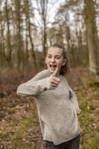 Portrait of a smiling young woman in forest