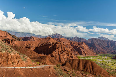 Scenic view of mountains against cloudy sky