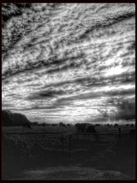 Scenic view of field against cloudy sky