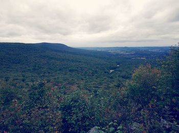 Scenic view of mountains against cloudy sky