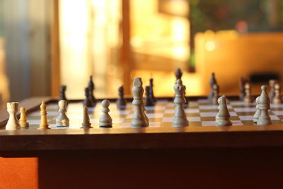 Close-up of chess board on table at home