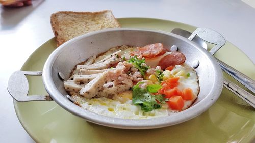 Kai krata, omelets in small pan with many ingredients for breakfast