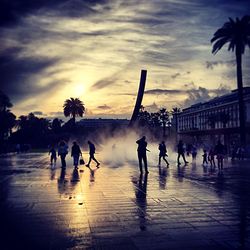 Silhouette of people at sunset