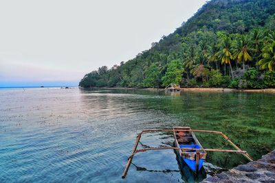 Scenic view of boat on sea against sky