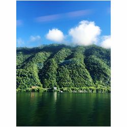 Scenic view of lake against cloudy sky