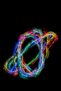Multi colored light painting against black background