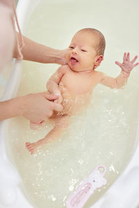 High angle view of woman swimming in bathroom