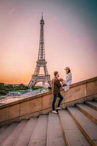 Romantic couple against eiffel tower during sunset