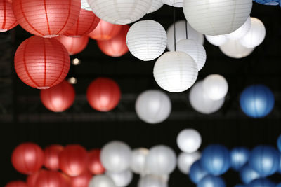 Low angle view of illuminated lanterns hanging at night