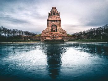 View of lake by building against sky