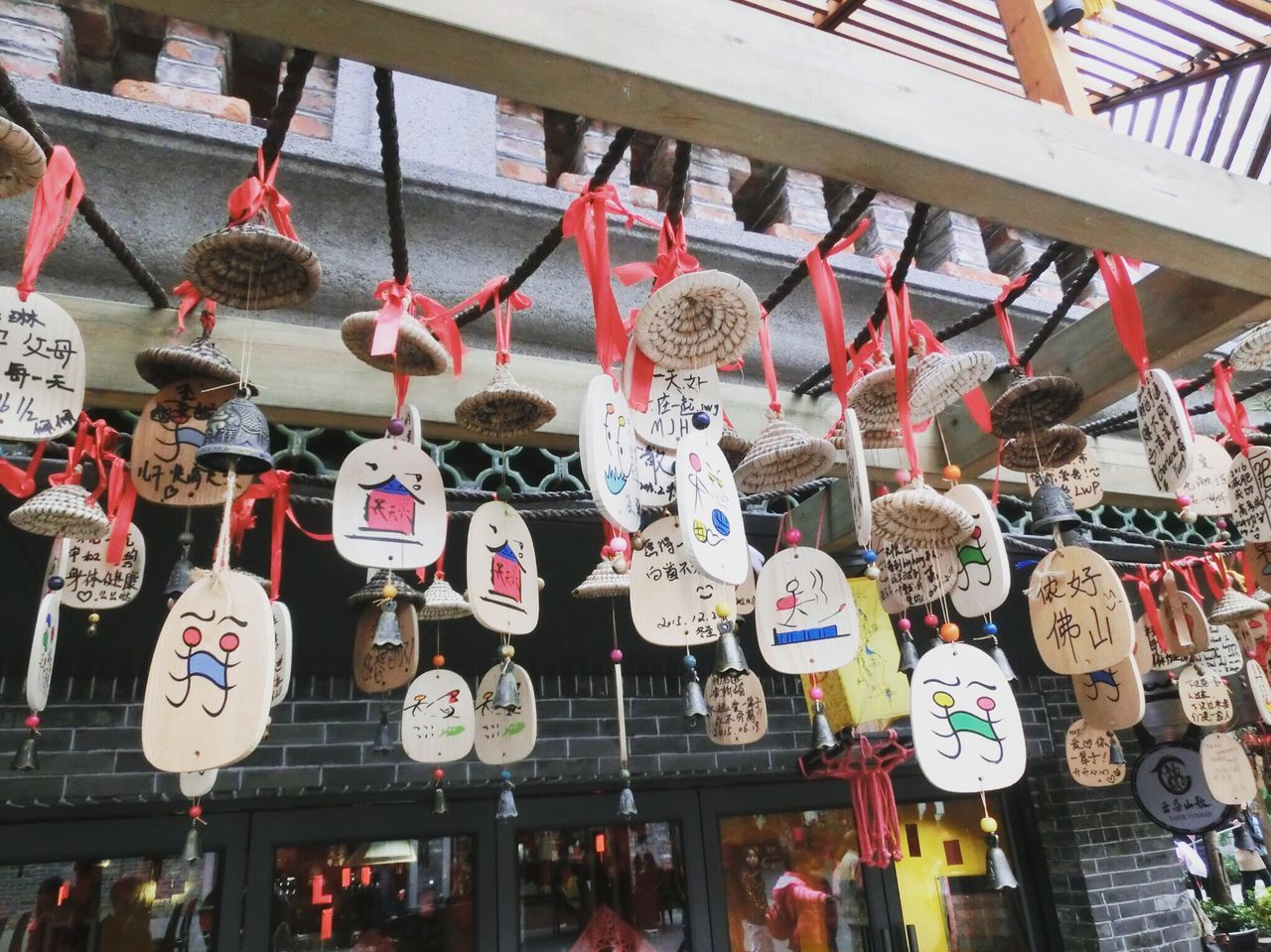 hanging, religion, spirituality, place of worship, indoors, cultures, tradition, retail, built structure, large group of objects, architecture, abundance, market, variation, decoration, for sale, in a row, lantern, culture
