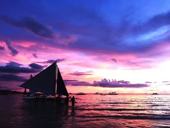 Sailboat on sea against sky during sunset