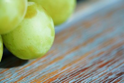 Macro view on fresh green grapes on wooden table