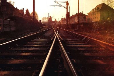 Railroad tracks in city against sky