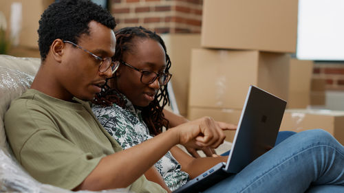 Couple using laptop at home