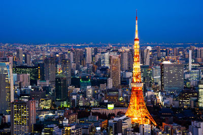 Aerial view of illuminated buildings in city at night