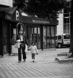 Woman walking on street in city