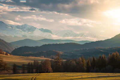 Scenic view of mountains against cloudy sky