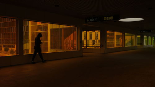 Man walking in illuminated building