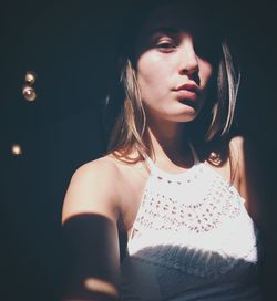 Sunlight falling on beautiful woman in darkroom