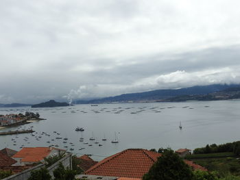 High angle view of lake by buildings against sky
