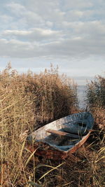 Boat on field against sky