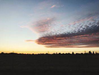 Silhouette landscape against sky during sunset