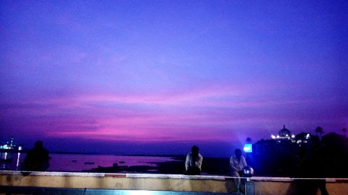 Scenic view of sea against cloudy sky at dusk