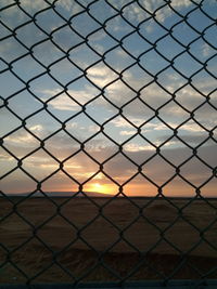 Full frame shot of chainlink fence at sunset