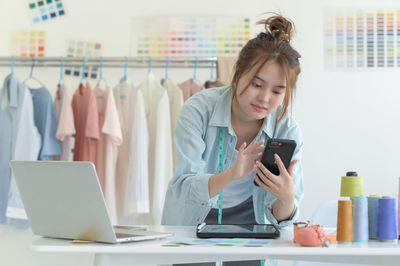 Young woman using mobile phone in cafe