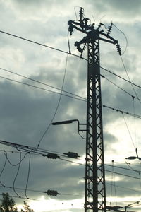 Low angle view of electricity pylon against sky