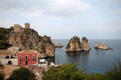 Panoramic view of sea and rocks against sky