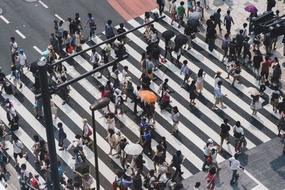 High angle view of crowd walking on zebra crossing