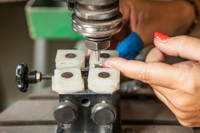 Close-up of woman holding equipment