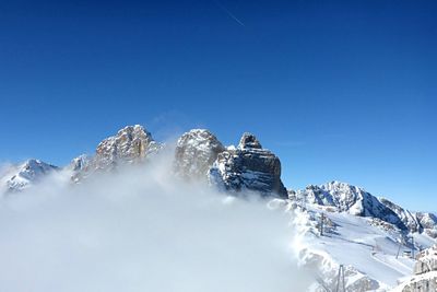 Scenic view of snowcapped mountains against clear blue sky