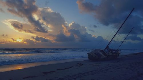 Scenic view of beach against sky during sunset
