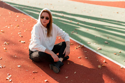 Portrait of young woman sitting outdoors