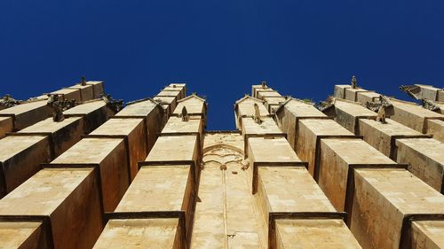 Low angle view of built structure against blue sky