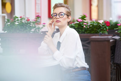 Young woman wearing eyeglasses on table