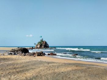 Scenic view of beach against clear sky