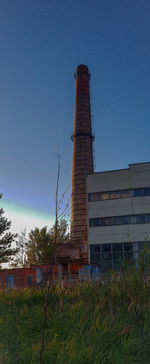 Low angle view of building against clear blue sky