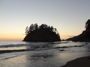 Scenic view of sea against clear sky during sunset