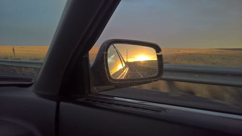 Close-up of side-view mirror on car window