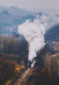 High angle view of smoke emitting train on railroad track
