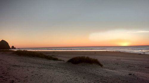 Scenic view of beach against sky during sunset