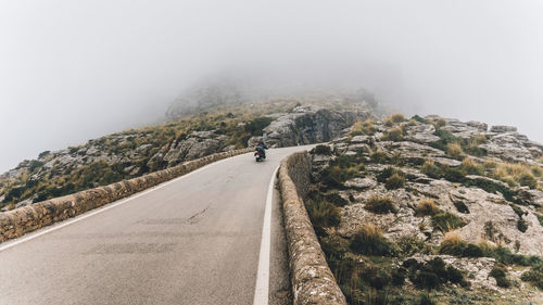 Road amidst mountains against sky