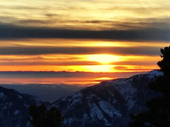 Scenic view of silhouette mountains against sky during sunset