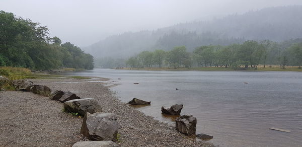 Scenic view of lake against sky during rainy season