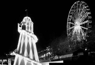 Low angle view of ferris wheel at night